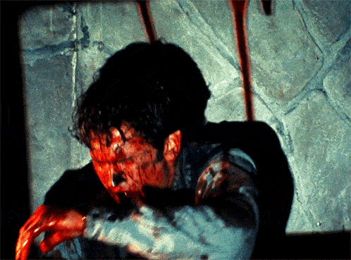 a man with blood coming out of his mouth and arms