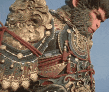 a statue of a man with a beard is wearing armor and looking down