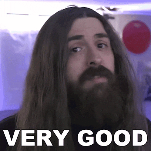 a man with long hair and a beard says " very good " in white letters