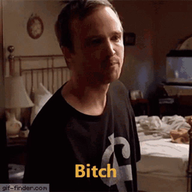 a man in a black shirt says bitch in a bedroom
