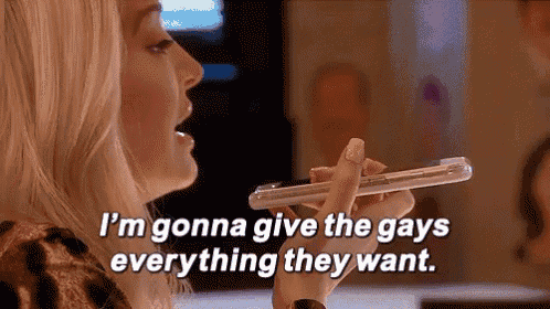 a woman is holding a cell phone in her hand and saying `` i 'm gonna give the gays everything they want ''