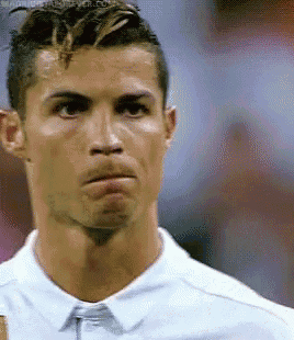 a close up of a man 's face with a white shirt and tie