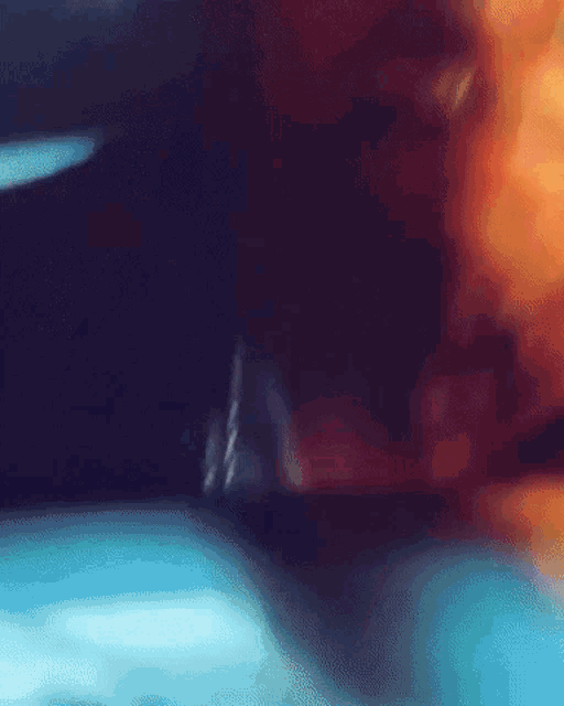 a blurry picture of a person 's face with a blue shirt on