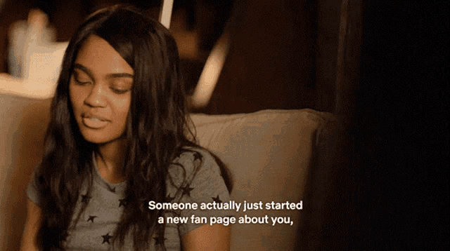 a woman is sitting on a couch with someone actually just started a new fan page about you