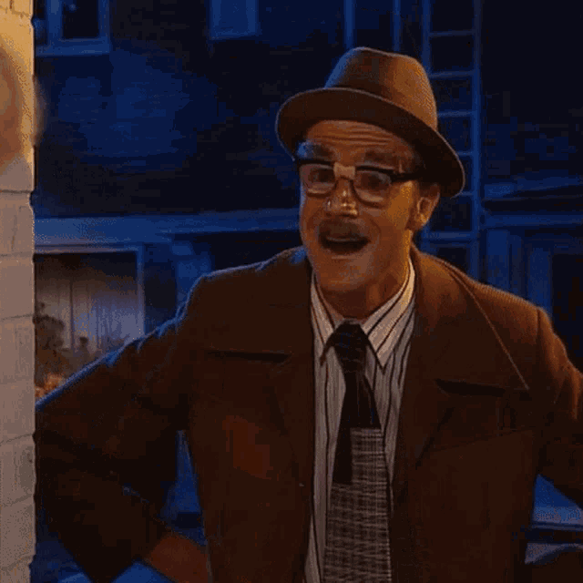 a man wearing a hat glasses and a tie
