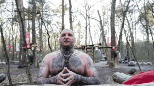 a shirtless man with a lot of tattoos on his body