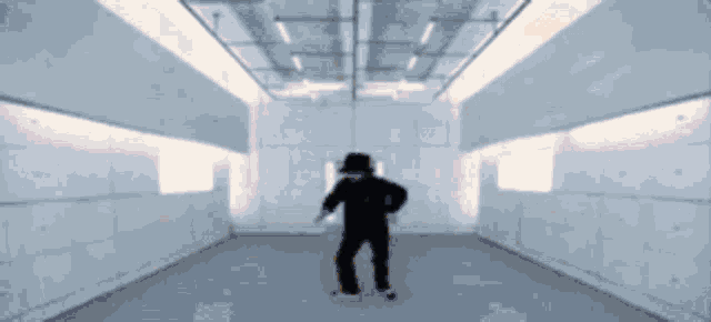 a silhouette of a man dancing in a room