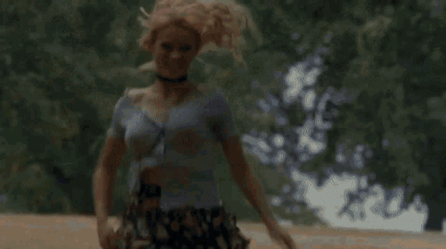a man and a woman are standing in a park and the woman is wearing leopard print tights