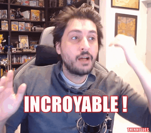 a man sitting in front of a microphone with the words incredible written on his face