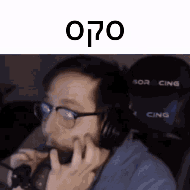a man wearing glasses and headphones is talking on a cell phone ..