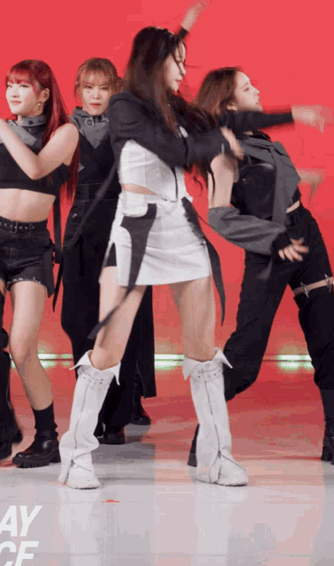 a group of women are dancing in front of a red background that says ay cf on it