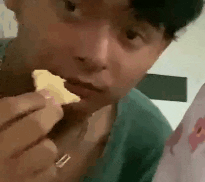 a close up of a person eating a slice of pizza .