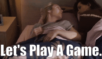 two women laying on a bed with the words let 's play a game