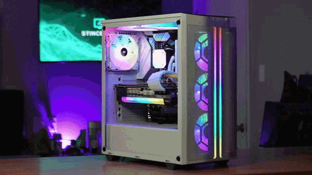 a white computer case is sitting on a table in front of a television that says stinger