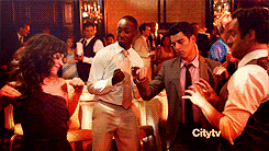 a group of people are dancing in a room with the city tv logo in the corner