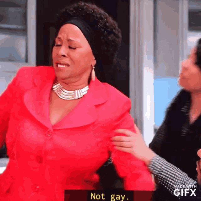 a woman in a red jacket says not gay in a gif