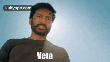 a man with a beard and mustache is standing in front of a blue sky and the sun is shining on his face .