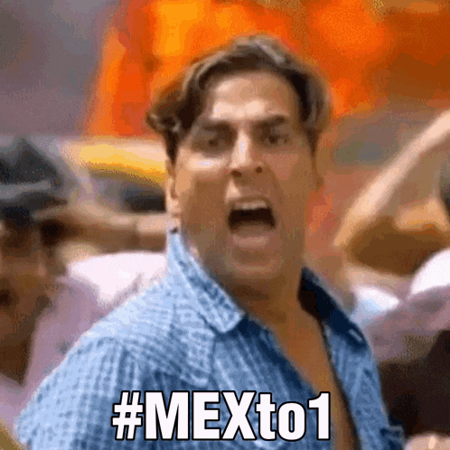a man in a blue shirt is screaming with # mexto1 written on his face