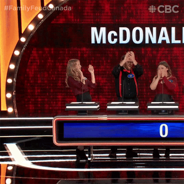 a group of people on a stage with a sign that says mcdonald 's