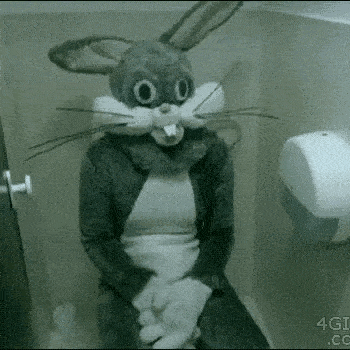 a person wearing a bunny costume is sitting on a toilet .
