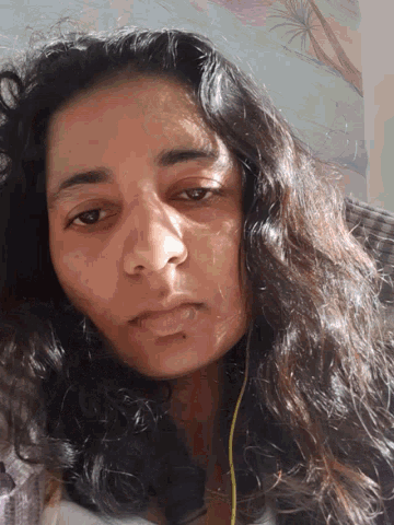 a close up of a woman 's face with the sun shining on her face