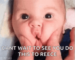 a baby is making a funny face while holding his hands to his mouth .