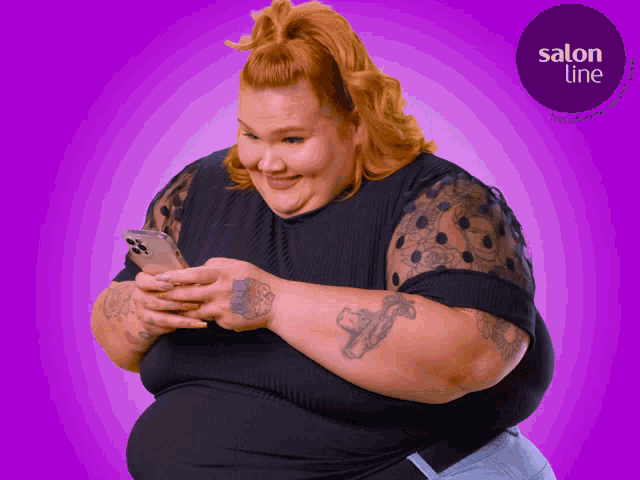 a woman with red hair is looking at her phone with a salon line logo in the background