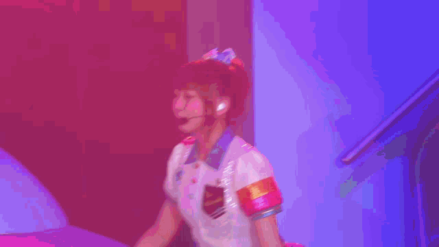 a girl with a microphone on her head is sitting on a couch
