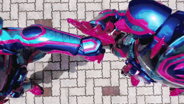 a couple of robots are standing next to each other on a sidewalk .