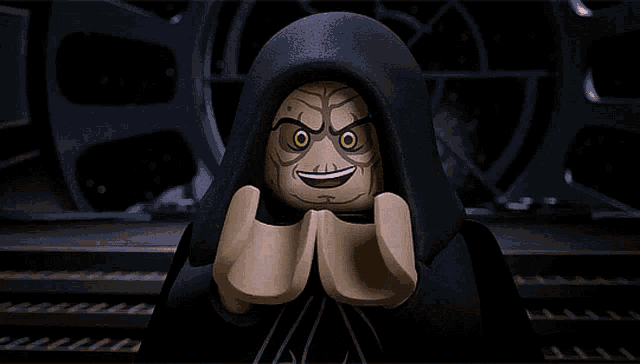 a lego star wars character is smiling with his hands folded in front of his face