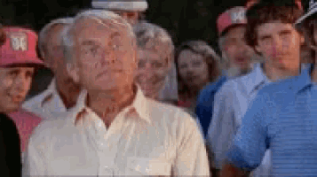 a man in a white shirt is standing in a crowd