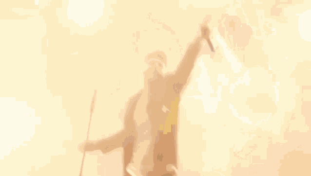 a man in a suit is holding a microphone on stage