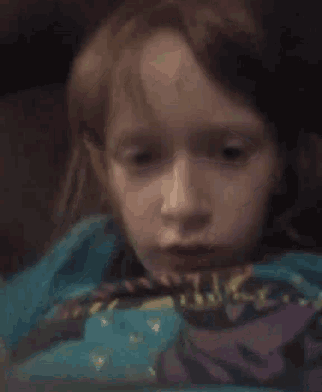 a close up of a child 's face wearing a shirt that says ' hulk ' on it