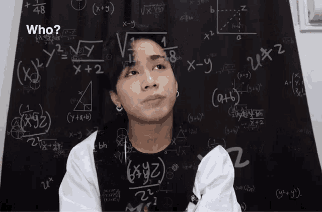 a man stands in front of a blackboard with mathematical equations on it and the question who is written above him