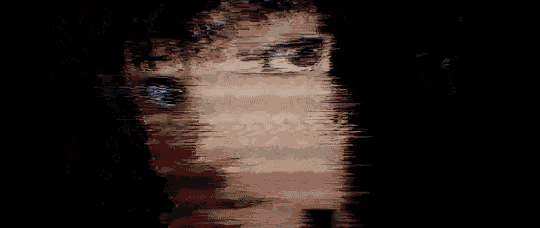 a close up of a woman 's face with a pixelated effect
