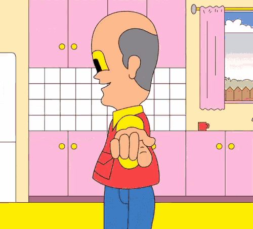 a man in a red vest is standing in a kitchen