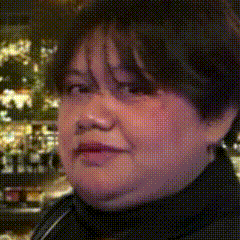 a close up of a woman 's face with a blurred background