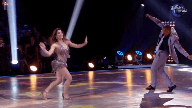 a man and a woman are dancing on a dance floor with dancing brasil written on the bottom