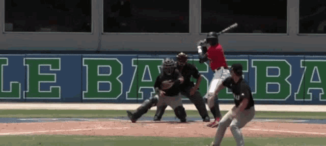 a baseball player is swinging a bat in front of a banner that says le ba