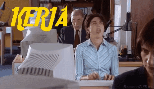 a woman sitting in front of a computer with the word kerja in yellow letters
