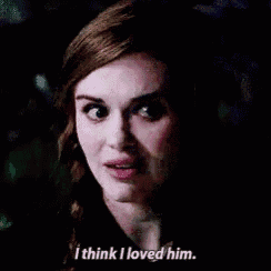 a close up of a woman 's face with the words `` i think i loved him '' written below her .