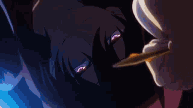 a close up of a person 's face with red eyes holding a knife .