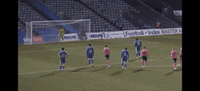 a group of soccer players on a field with a sign that says sky bet
