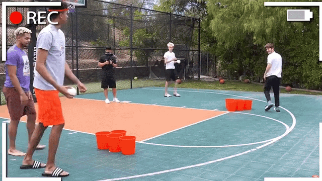 a group of men are playing a game on a basketball court and the word rec is on the bottom right