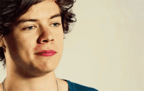 a close up of a man 's face with pink lipstick on his lips
