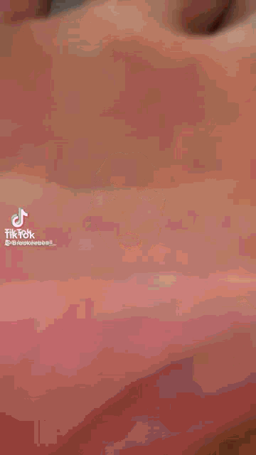 a close up of a person 's hand with a tik tok logo on it