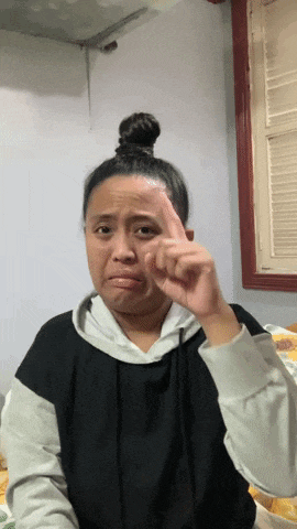 a woman with a bun on her head is making a face