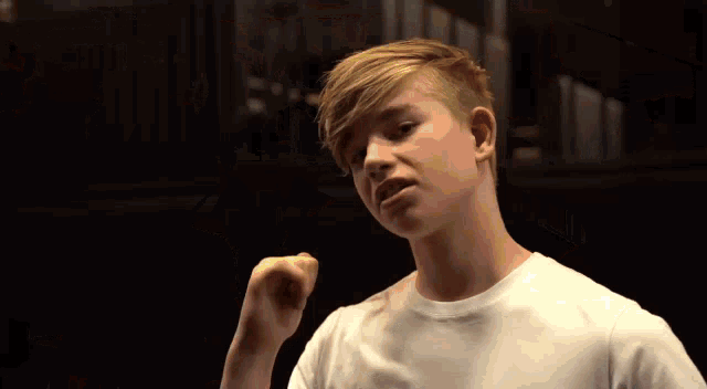 a boy wearing a white t-shirt that says f4urge