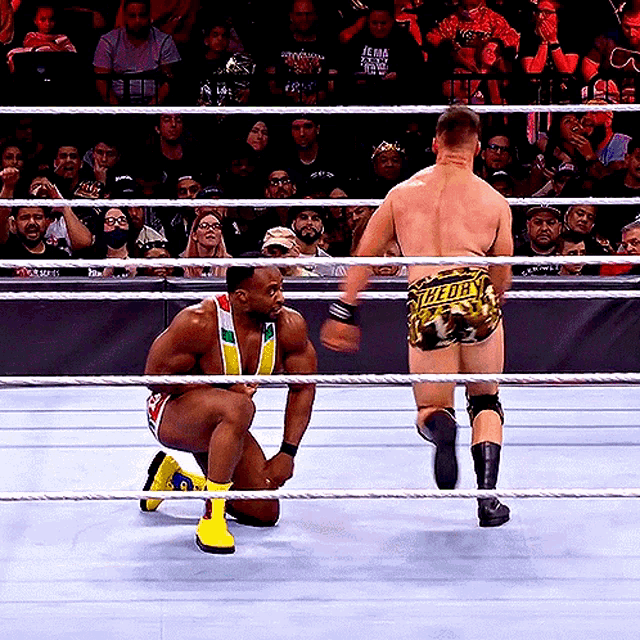 a man in a wrestling ring wearing shorts that say ' t-for ' on them