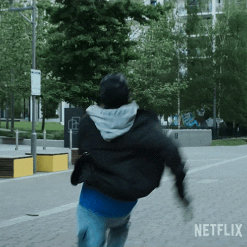 a person is running down a street with a netflix logo in the corner